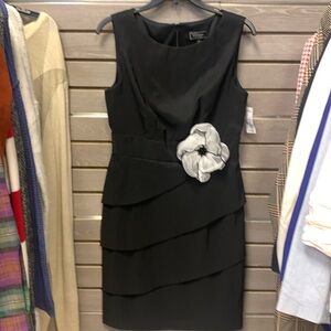 Black dress barn dress with white silk flower.